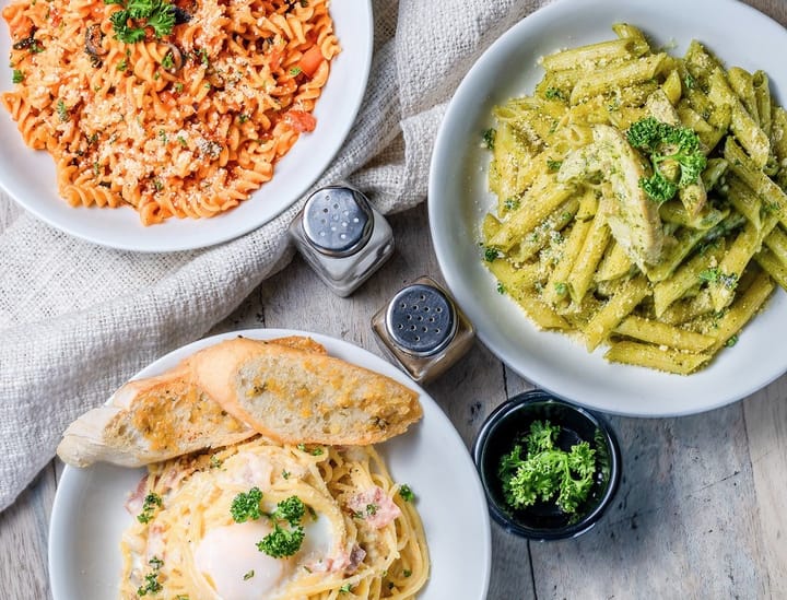 Colorful Barilla F1 pasta shapes arranged on a wooden table, showcasing innovative design and culinary creativity.
