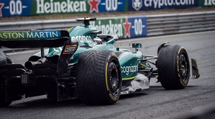 Aston Martin F1 car rotates under braking at Zandvoort’s Turn 1, rear wing, suspension and tyres dominating.